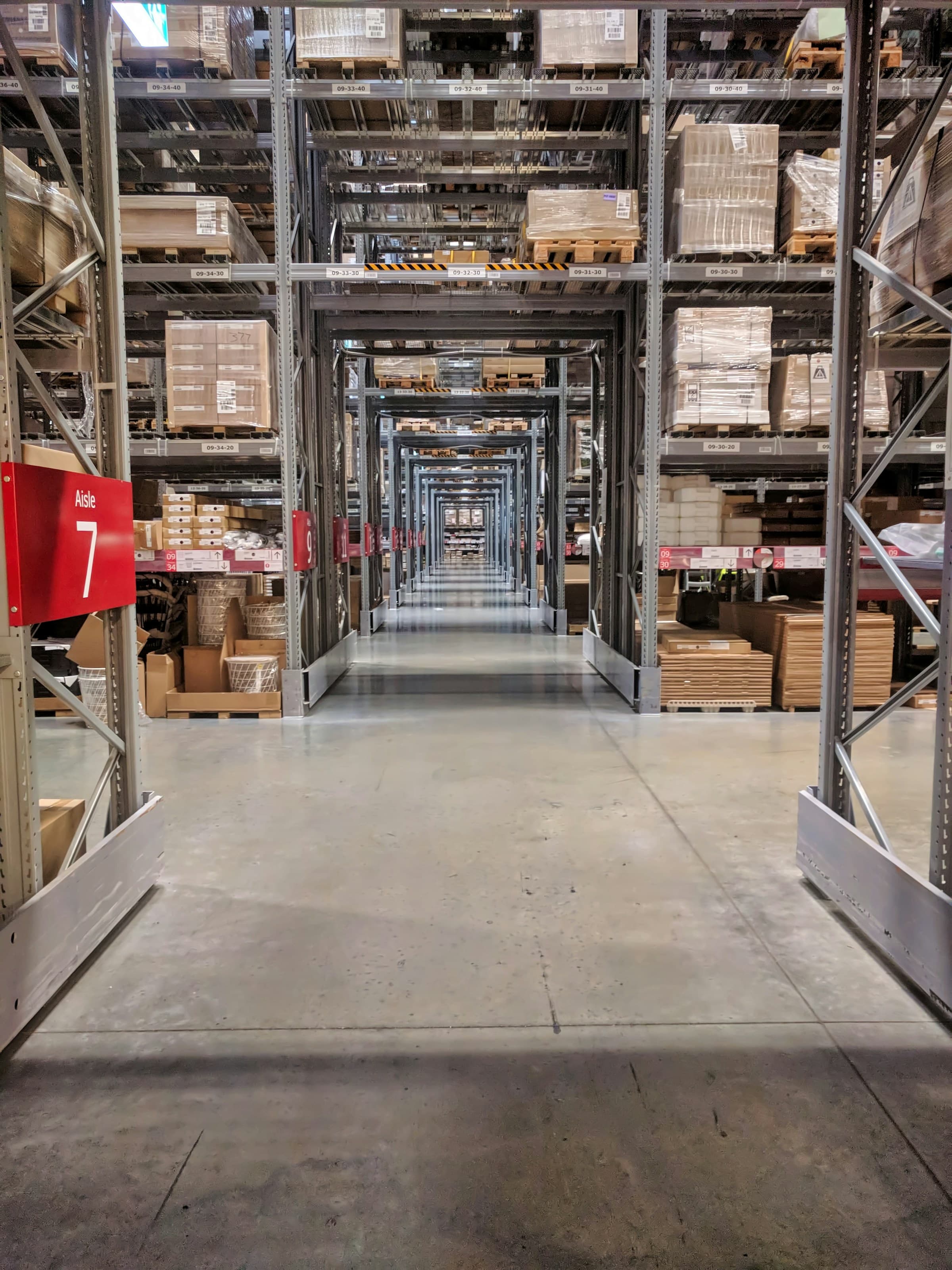 Warehouse storage aisles with shelves full of wholesale products